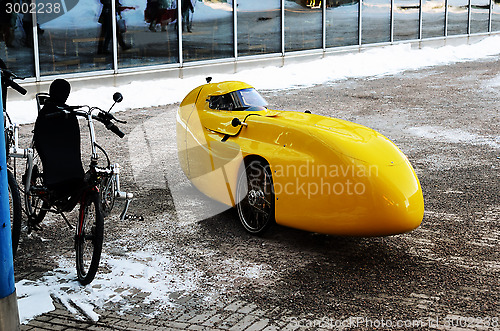 Image of yellow recumbent parked at the office