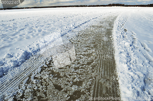 Image of road and tracks on frozen snowcovered lake