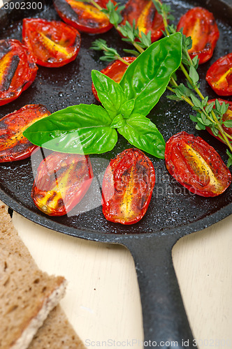 Image of baked cherry tomatoes with basil anf thyme