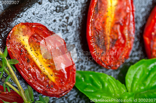 Image of baked cherry tomatoes with basil anf thyme