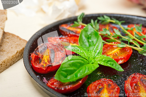 Image of baked cherry tomatoes with basil anf thyme