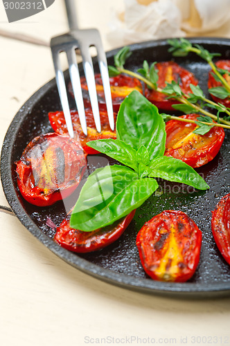 Image of baked cherry tomatoes with basil anf thyme