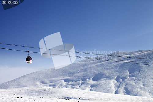 Image of Gondola lift and ski slope at nice sun day