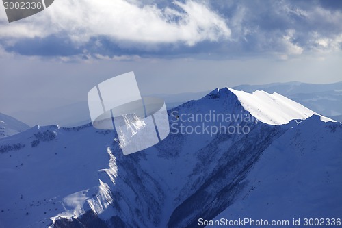 Image of Winter mountains and helicopter in evening