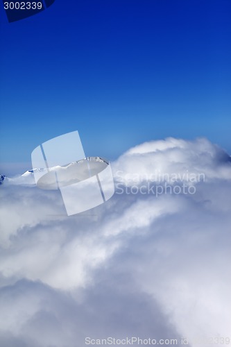 Image of Mountains under clouds at sun day