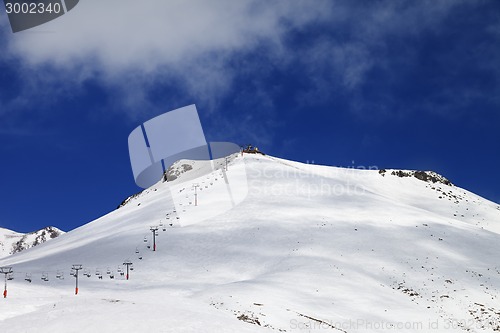 Image of Ropeway and ski slope in sun day