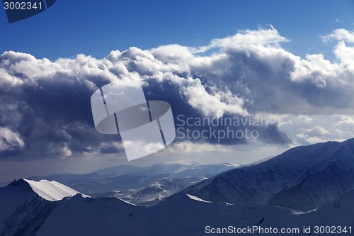 Image of Winter mountains in evening and sunlight clouds