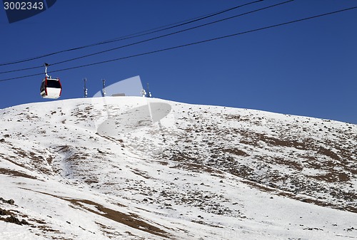 Image of Gondola lifts and slope with stones