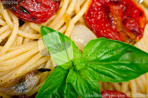 Image of spaghetti pasta with baked cherry tomatoes and basil 