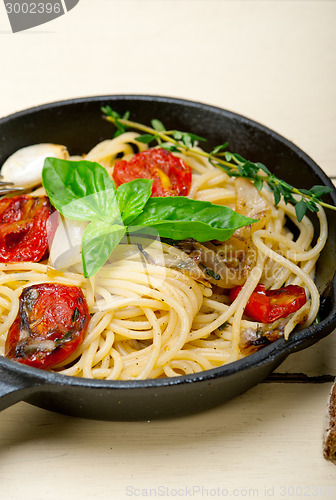 Image of spaghetti pasta with baked cherry tomatoes and basil 