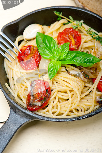 Image of spaghetti pasta with baked cherry tomatoes and basil 