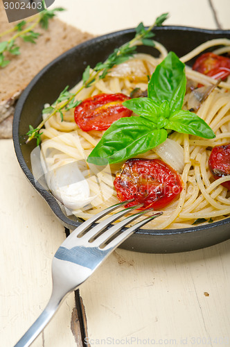 Image of spaghetti pasta with baked cherry tomatoes and basil 