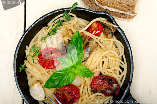 Image of spaghetti pasta with baked cherry tomatoes and basil 