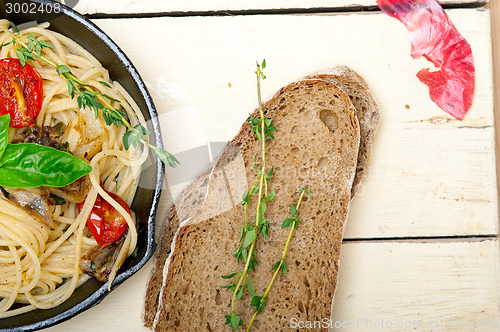 Image of spaghetti pasta with baked cherry tomatoes and basil 