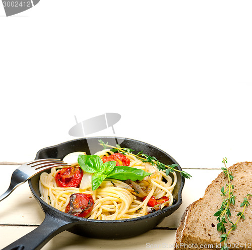 Image of spaghetti pasta with baked cherry tomatoes and basil 