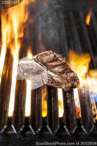 Image of T-bone steak on the barbecue