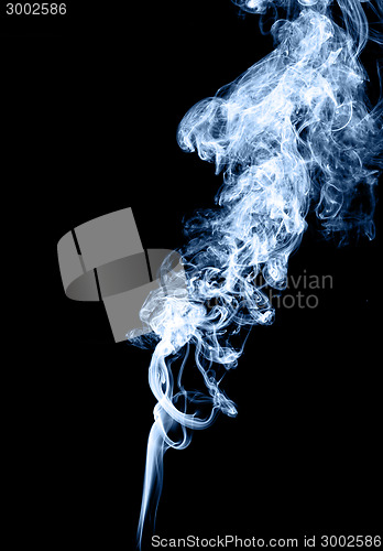Image of Real blue smoke over black background