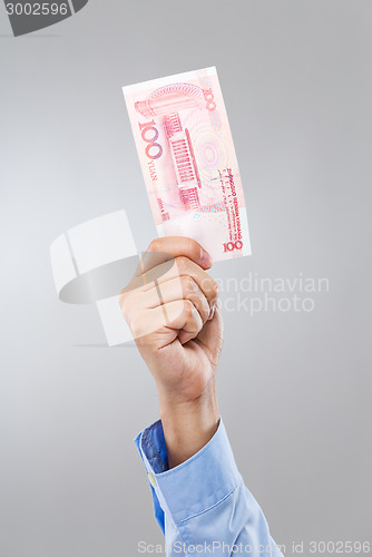 Image of Businessman hand hold with hundred RMB