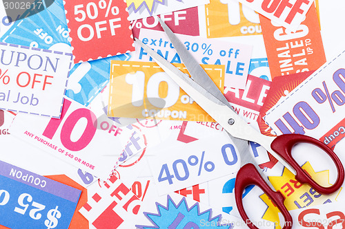 Image of Money saving coupon vouchers with scissors