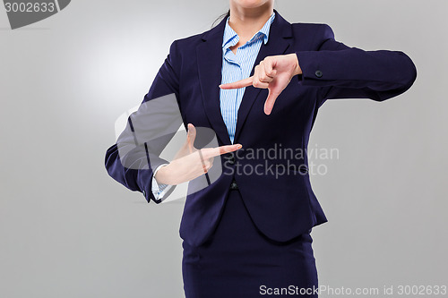 Image of Businesswoman two hand build frame together