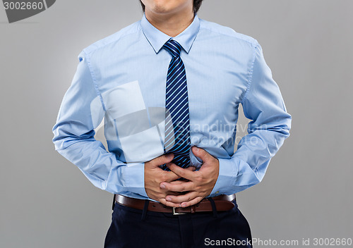 Image of Businessman with stomachache