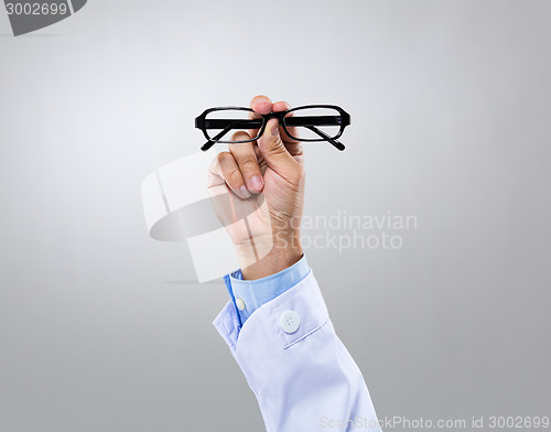 Image of Optician doctor hold with eye glasses