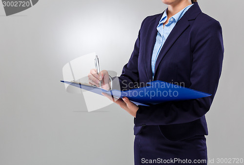 Image of Businesswoman write on clipboard