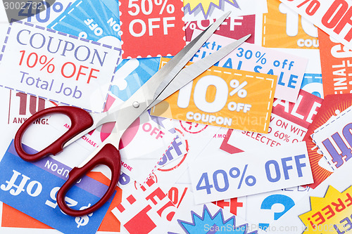 Image of Money saving coupon vouchers with scissors
