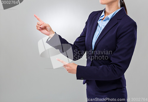 Image of Businesswoman two finger point aside