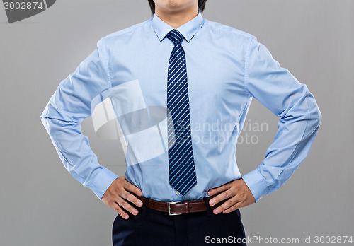 Image of Businessman with hand on waist