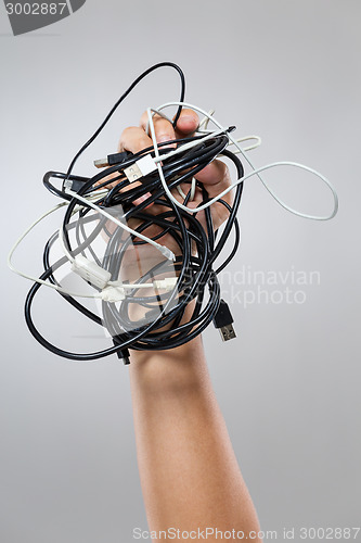 Image of Hand hold with messy cable
