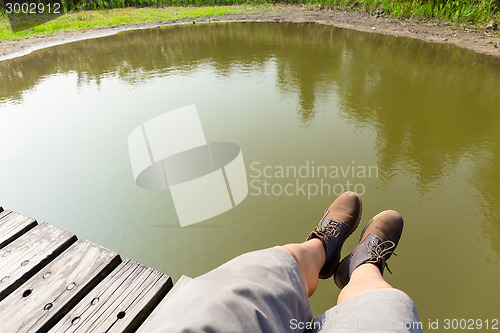 Image of Man with hiking shoes on wooden floor