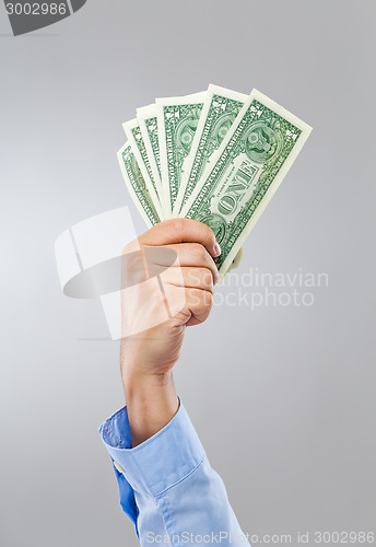 Image of Businessman hand hold group of banknote