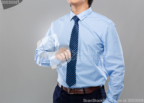 Image of Businessman hand hold with necktie