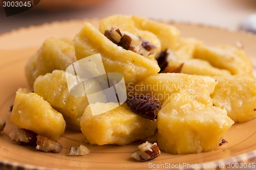Image of homemade pumpkin gnocchi with pecan nuts