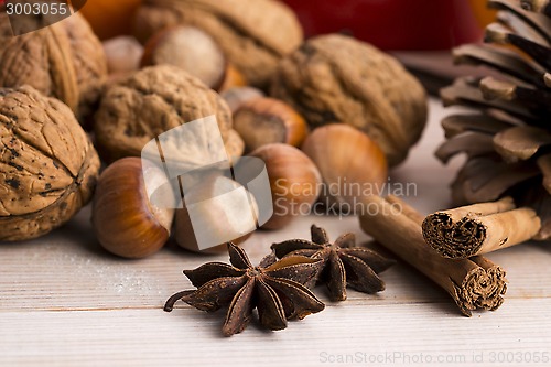 Image of Different kinds of spices, nuts and dried oranges - christmas de