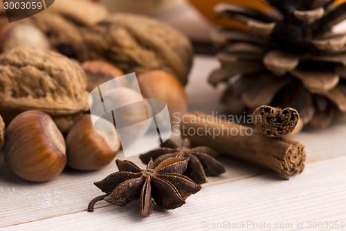 Image of Different kinds of spices, nuts and dried oranges - christmas de