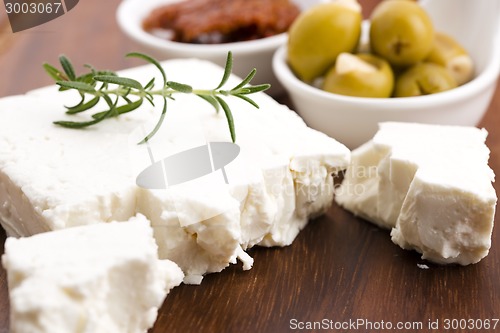 Image of Feta cheese with olives, sun dried tomatoes and fresh herbs