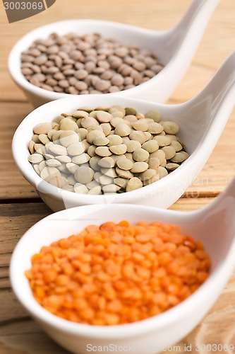 Image of Three kinds of lentil in bowls - red lentil, green lentil and br