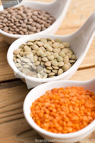 Image of Three kinds of lentil in bowls - red lentil, green lentil and br