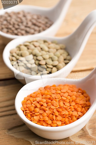 Image of Three kinds of lentil in bowls - red lentil, green lentil and br