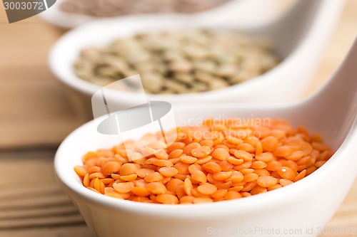 Image of Three kinds of lentil in bowls - red lentil, green lentil and br