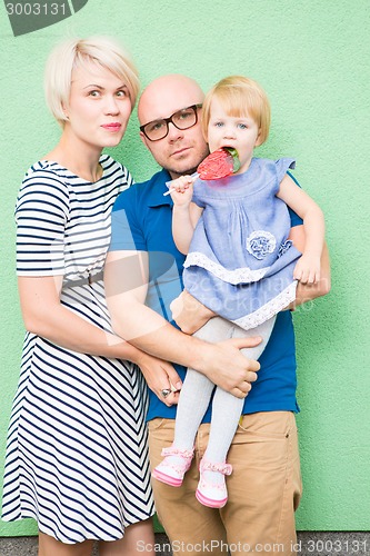 Image of Happy mother, father and daughter