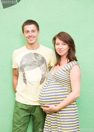 Image of Beautiful young couple expecting baby