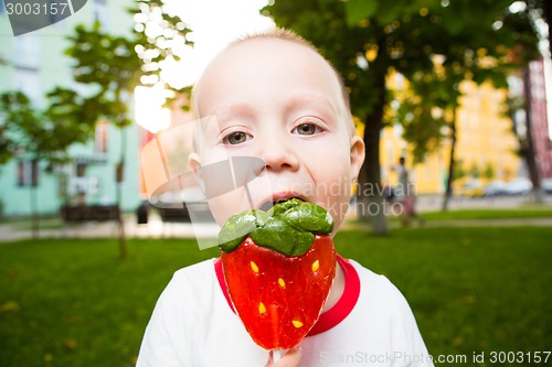 Image of young boy with colorful lollipop