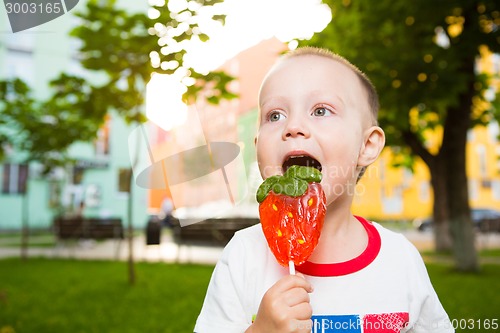 Image of young boy with colorful lollipop