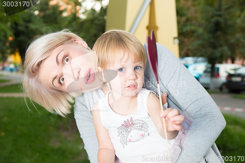 Image of portrait of beautiful mother and kid girl outdoors in park