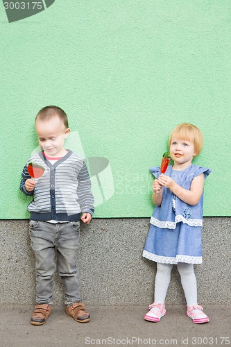 Image of Adorable little kids with colorful lollipops