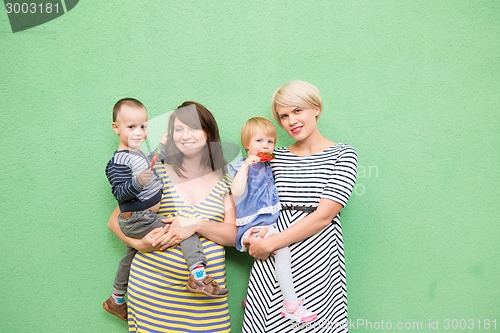 Image of two beautiful girls with a children