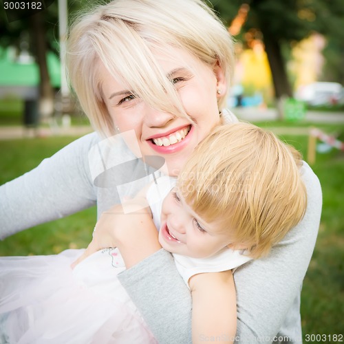 Image of portrait of beautiful mother and kid girl outdoors in park